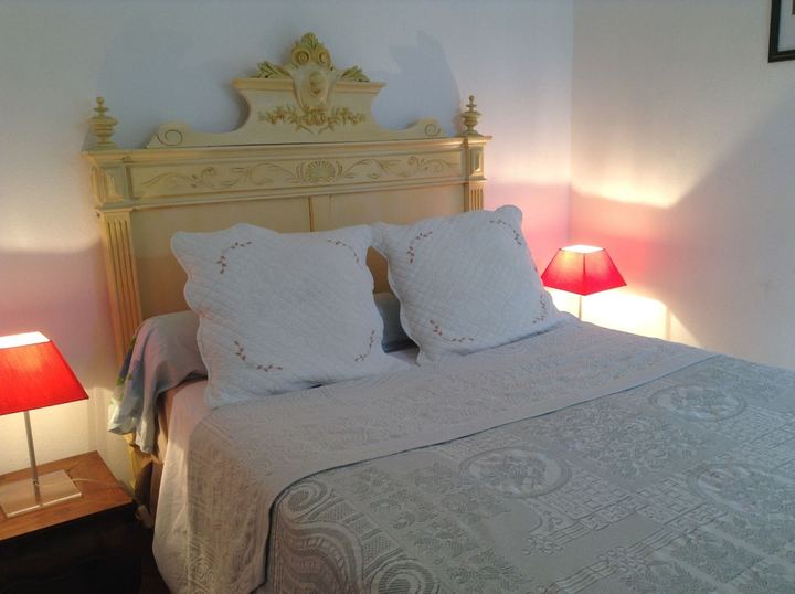 Chambre de la Villa SOLEDAD avec lit double à tête de lit ancienne et lampes de chevet